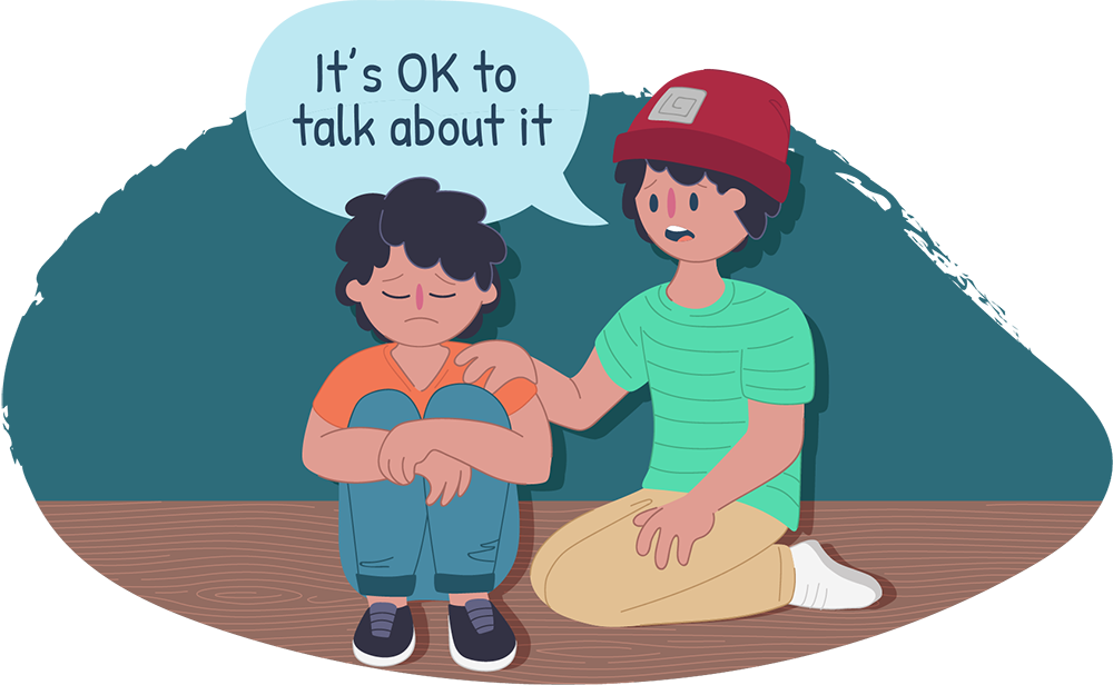 Two boys sitting down together, one looks sad, the other is saying it's ok to talk